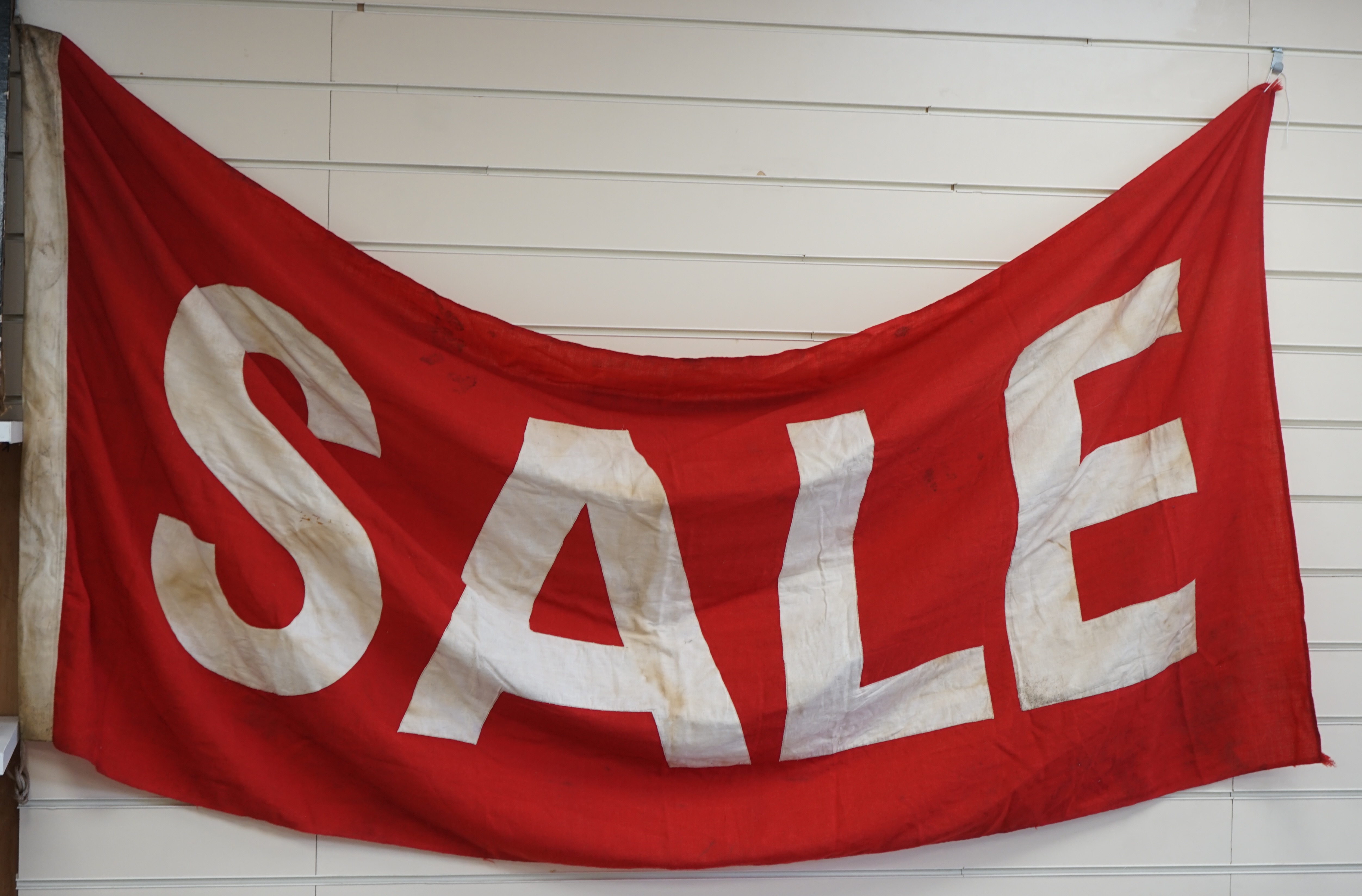 A vintage Union flag, approximately 240 x 120cm, a smaller “Sale” flag and other assorted flags and bunting. Condition - fair